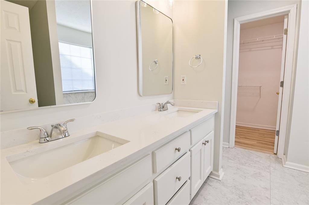 1255 Summit Point Lane Snellville, GA 30078 - Photo 22 of 41 a bathroom with double sink and a mirror