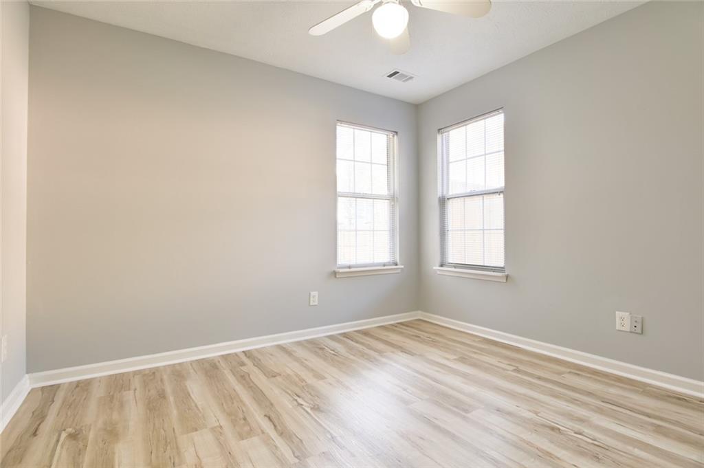 1255 Summit Point Lane Snellville, GA 30078 - Photo 27 of 41 wooden floor in an empty room with a window