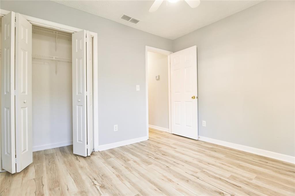 1255 Summit Point Lane Snellville, GA 30078 - Photo 28 of 41 an empty room with wooden floor and closet