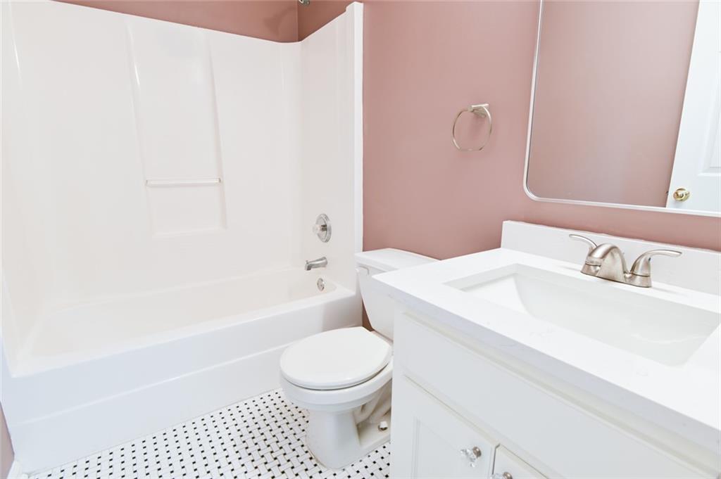 1255 Summit Point Lane Snellville, GA 30078 - Photo 29 of 41 a bathroom with a sink a toilet and a bathtub