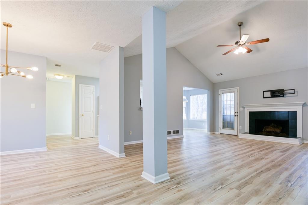 1255 Summit Point Lane Snellville, GA 30078 - Photo 3 of 41 a view of a livingroom with a fireplace a ceiling fan and wooden floor