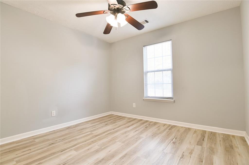 1255 Summit Point Lane Snellville, GA 30078 - Photo 32 of 41 an empty room with a window and a fan