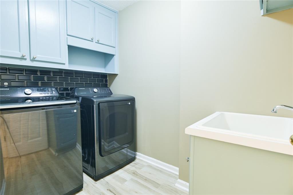 1255 Summit Point Lane Snellville, GA 30078 - Photo 33 of 41 a utility room with a sink washer and dryer