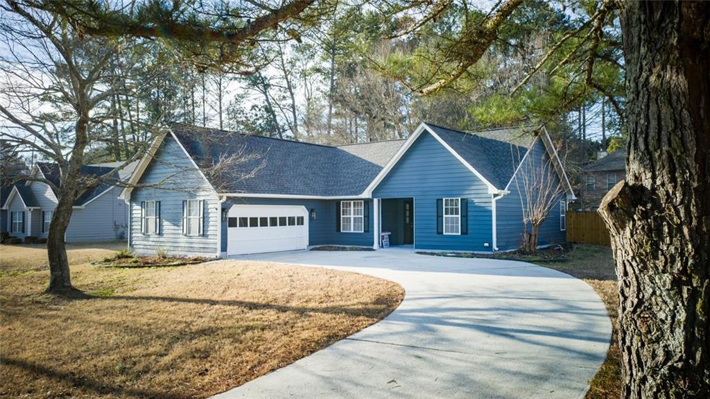 1255 Summit Point Lane Snellville, GA 30078 - Photo 38 of 41 a front view of a house with a yard covered in snow