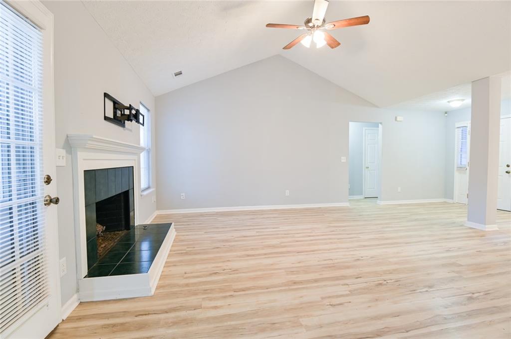 1255 Summit Point Lane Snellville, GA 30078 - Photo 6 of 41 a view of empty room with wooden floor and fireplace