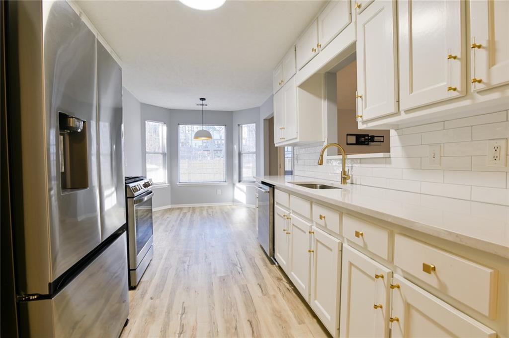 1255 Summit Point Lane Snellville, GA 30078 - Photo 9 of 41 a kitchen with cabinets a sink and appliances