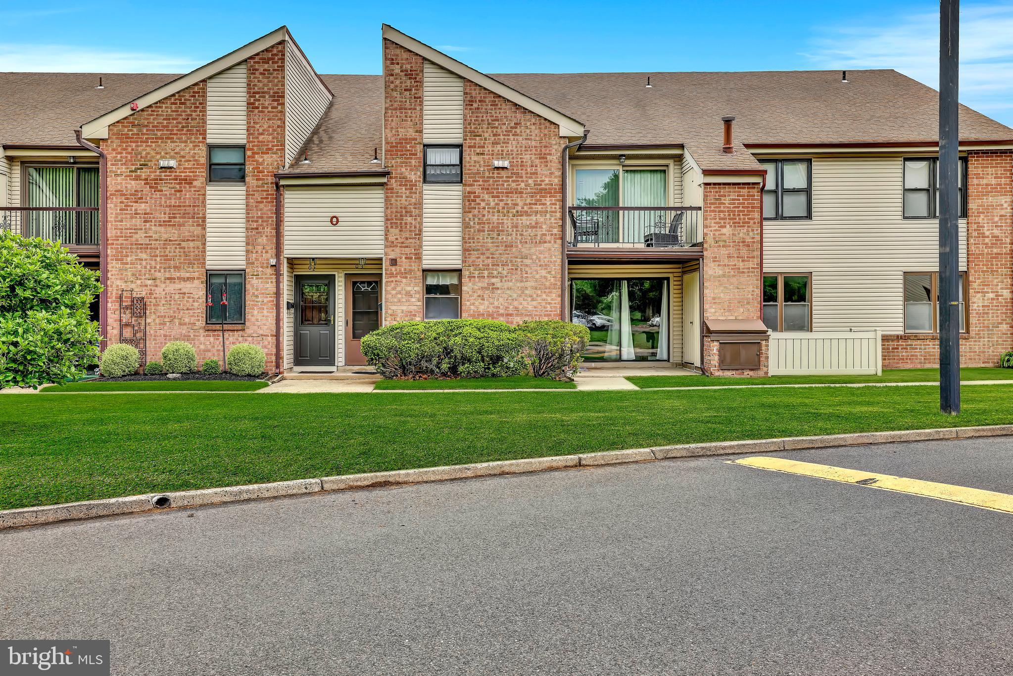 Charming brick facade with inviting greenery.