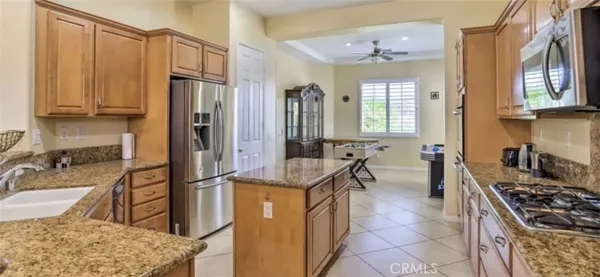 a kitchen with refrigerator a stove and a sink