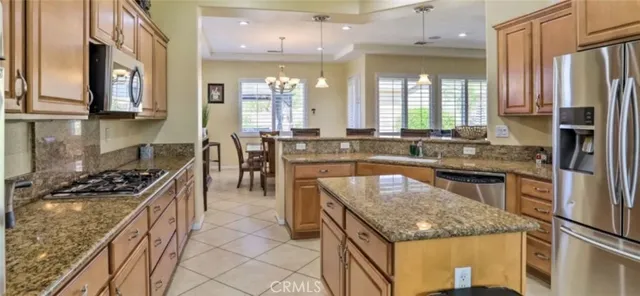 a kitchen with stainless steel appliances granite countertop a stove and a sink