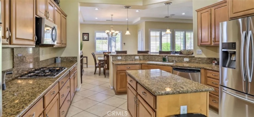 43277 Sentiero Drive Indio, CA 92203 - Photo 13 of 54 a kitchen with stainless steel appliances granite countertop a stove and a sink