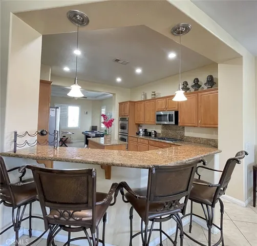 a large kitchen with a table and chairs