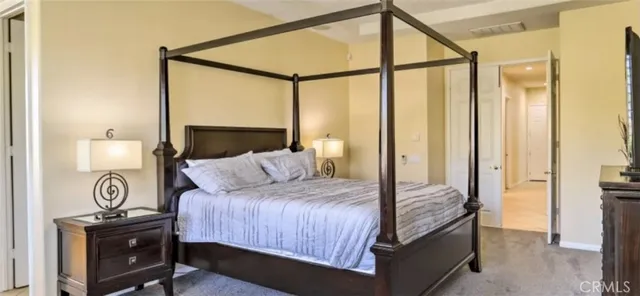 a bedroom with a bed and a table