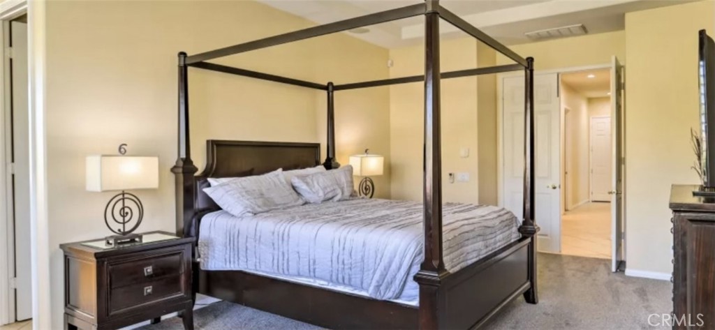 43277 Sentiero Drive Indio, CA 92203 - Photo 22 of 54 a bedroom with a bed and a table