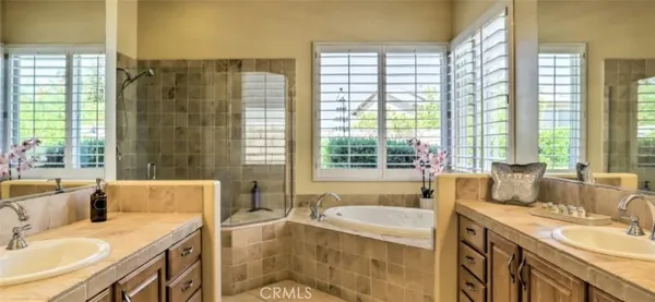 a spacious bathroom with sink shower and bathtub