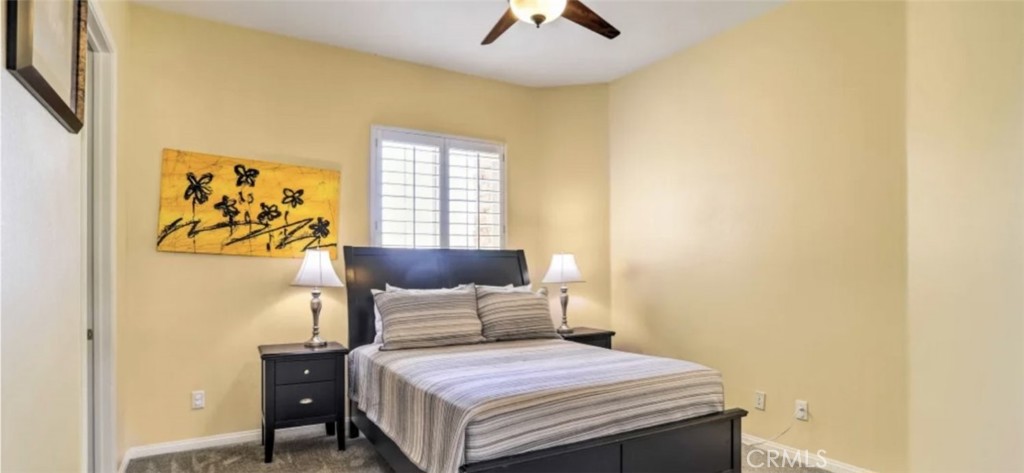 43277 Sentiero Drive Indio, CA 92203 - Photo 26 of 54 a bedroom with a bed and a painting on the wall