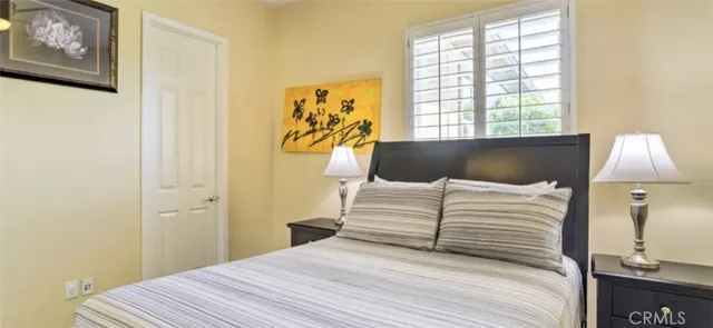 a bedroom with a bed and window