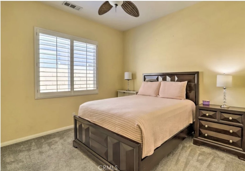 43277 Sentiero Drive Indio, CA 92203 - Photo 28 of 54 a bedroom with a bed and window