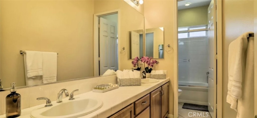 43277 Sentiero Drive Indio, CA 92203 - Photo 29 of 54 a bathroom with a granite countertop sink and a mirror