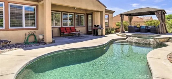 a swimming pool with outdoor seating yard and outdoor seating