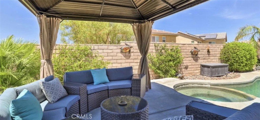 43277 Sentiero Drive Indio, CA 92203 - Photo 39 of 54 a balcony with furniture and a potted plant
