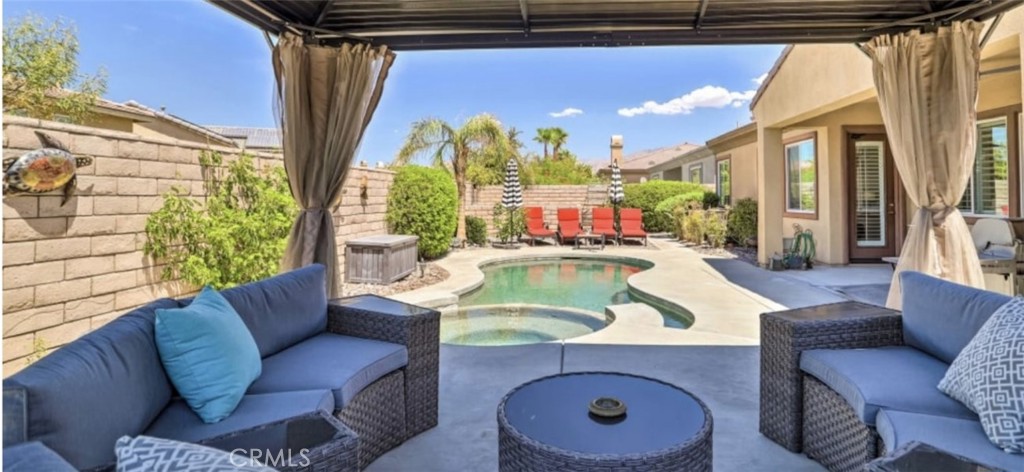 43277 Sentiero Drive Indio, CA 92203 - Photo 41 of 54 a living room with furniture and a large window