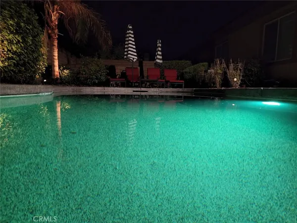 a view of a pool with sitting area