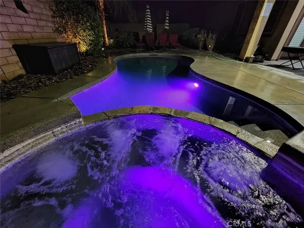 a view of swimming pool with outdoor seating