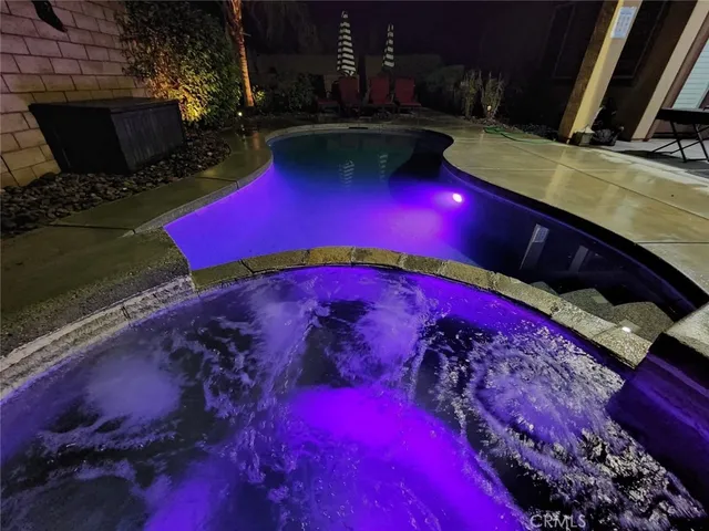 a view of swimming pool with outdoor seating