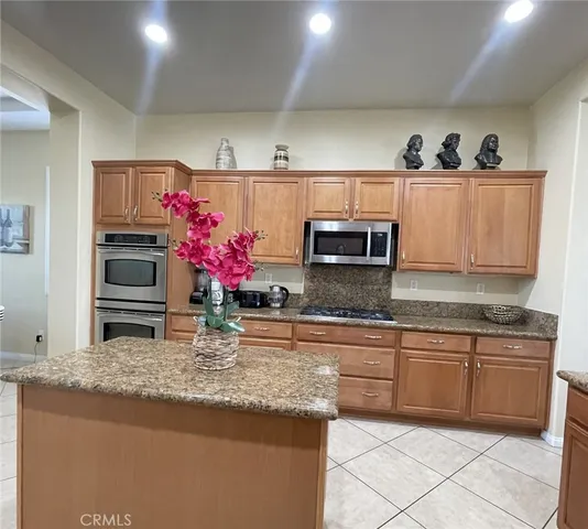 a kitchen with stainless steel appliances granite countertop a sink and cabinets