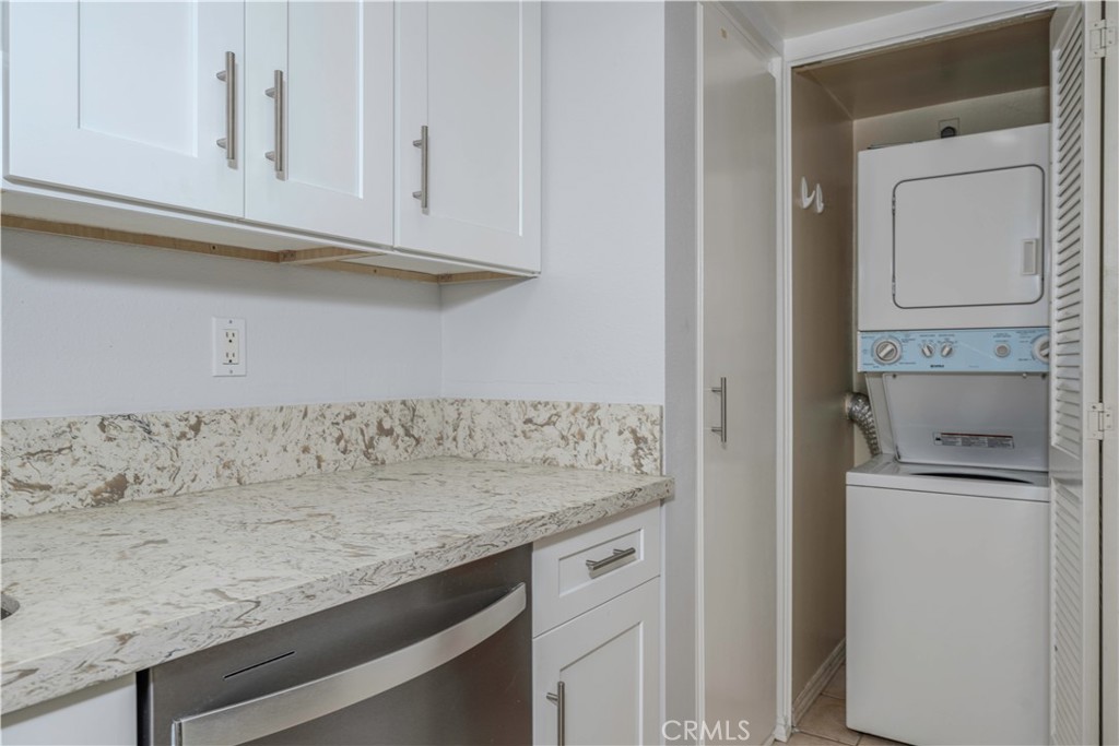 12660 Briarglen Loop, Unit G Stanton, CA 90680 - Photo 13 of 38 a kitchen with granite countertop white cabinets and a sink