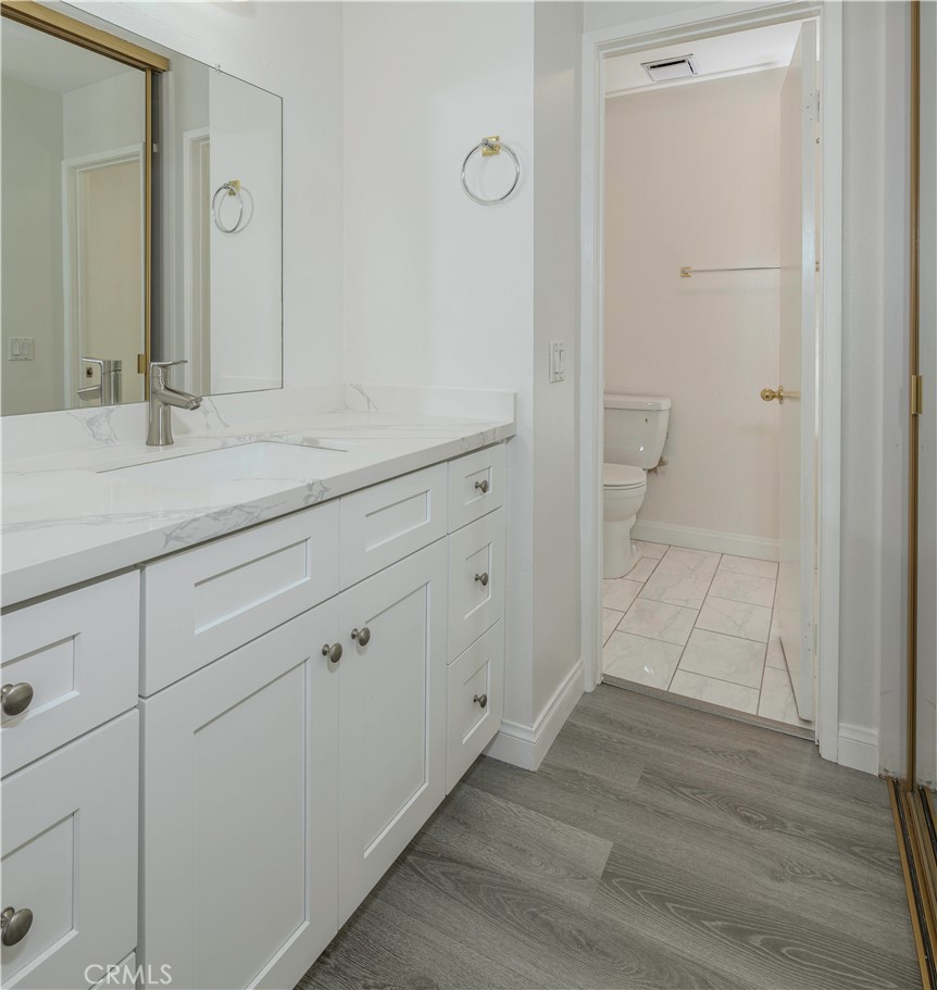 12660 Briarglen Loop, Unit G Stanton, CA 90680 - Photo 20 of 38 a bathroom with a sink and a mirror