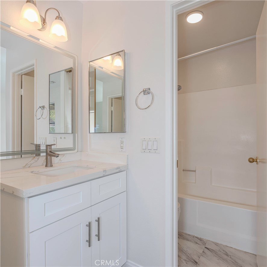 12660 Briarglen Loop, Unit G Stanton, CA 90680 - Photo 25 of 38 a bathroom with a sink and a mirror