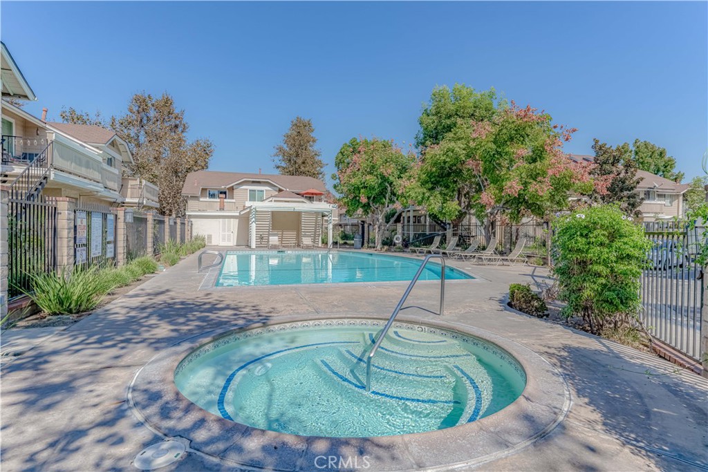 12660 Briarglen Loop, Unit G Stanton, CA 90680 - Photo 32 of 38 a swimming pool with outdoor seating and plants