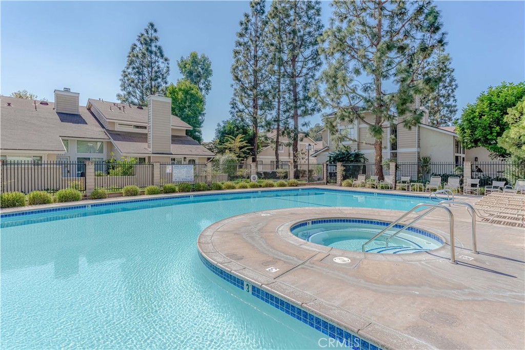 12660 Briarglen Loop, Unit G Stanton, CA 90680 - Photo 35 of 38 a view of swimming pool with outdoor seating and trees in the background