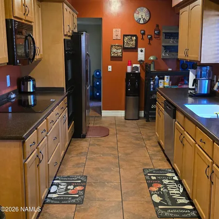 a kitchen with stainless steel appliances granite countertop a refrigerator and a stove