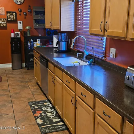 a kitchen with stainless steel appliances granite countertop a coffee maker on the counter tops and a granite counter tops