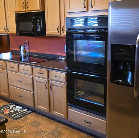 a kitchen with granite countertop white cabinets and appliances