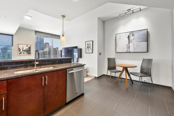 a kitchen with stainless steel appliances granite countertop a refrigerator and a sink