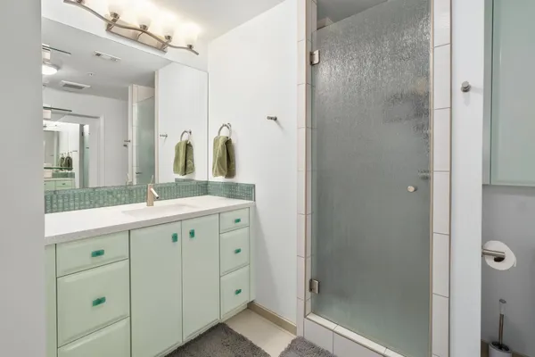 a spacious bathroom with a double vanity sink and mirror