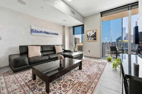 a living room with furniture and a rug