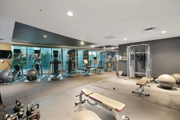 a room with gym equipment and large window