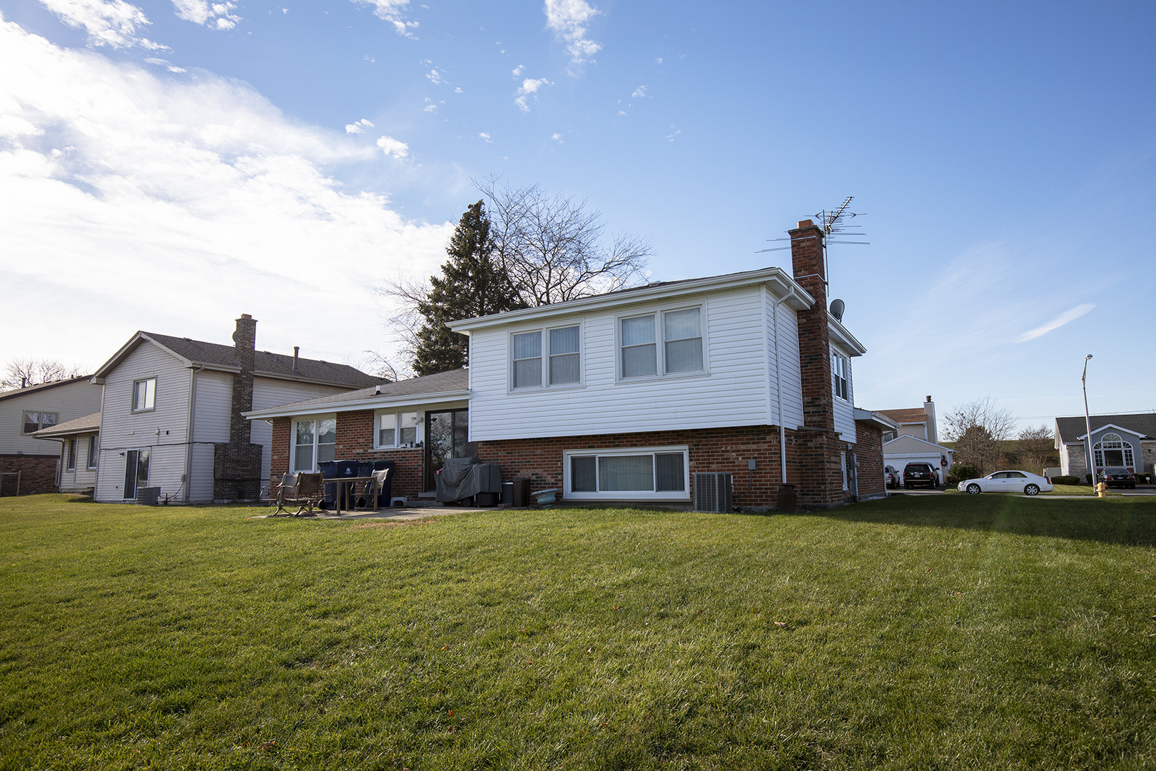 433 Highland Road Matteson, IL 60443 - Photo 3 of 27 a view of a house with a big yard and large trees
