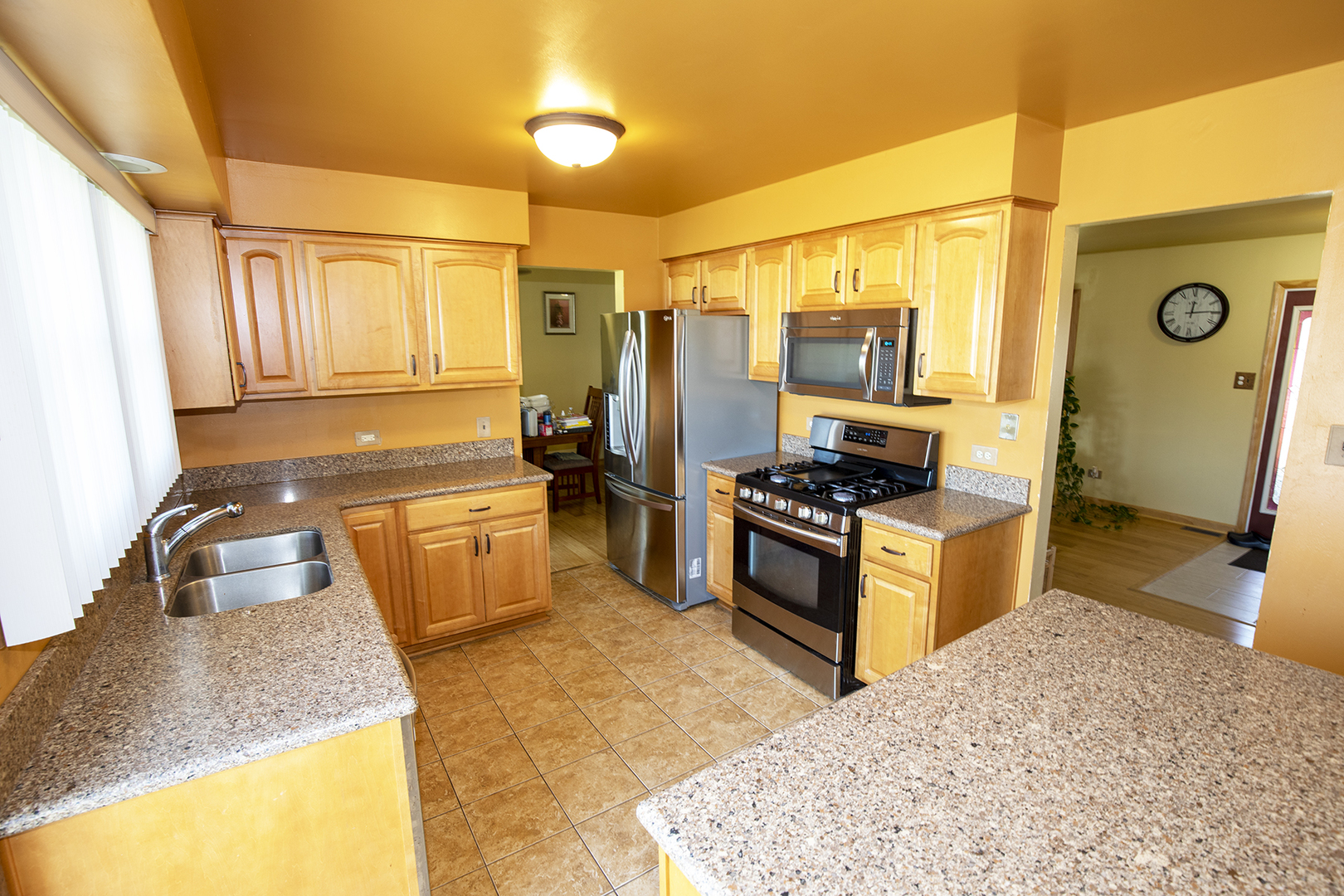 433 Highland Road Matteson, IL 60443 - Photo 10 of 27 a kitchen with stainless steel appliances granite countertop a sink stove and refrigerator