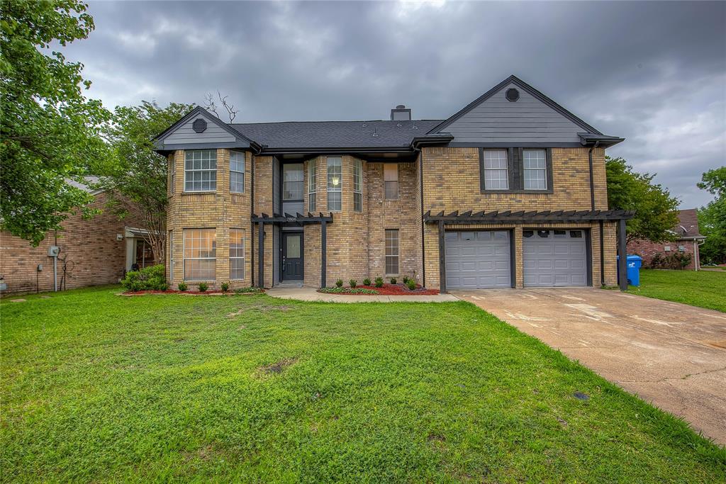 7806 Spinnaker Cove Rowlett, TX 75089 - Photo 1 of 1 a front view of a house with a garden and yard
