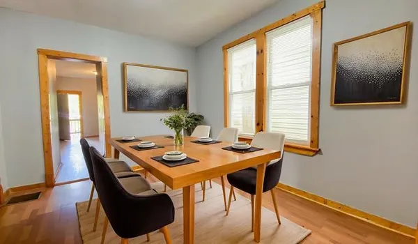 a dining room with furniture and window