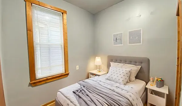 a bedroom with a bed and a window