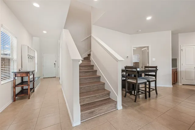 a view of a livingroom with furniture and stairs