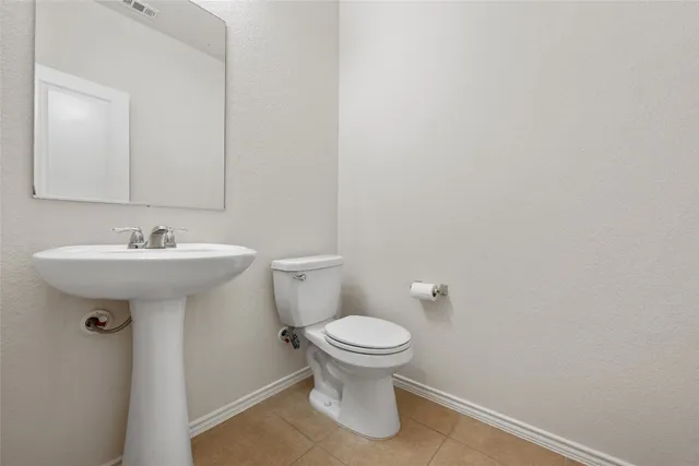 a bathroom with a sink toilet and a mirror