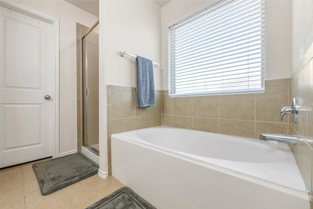 a white bath tub sitting next to a white sink
