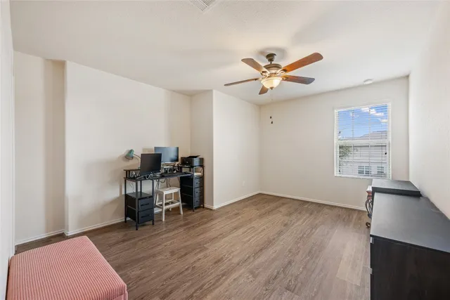 a view of a workspace with furniture and a window